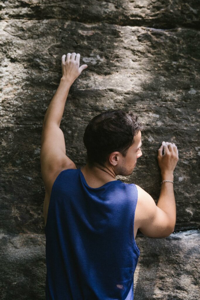 Man climbing rock wall choosing self compassion and mindfulness