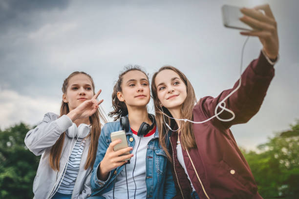 3 teens taking a selfie dangers of teens on TikTok