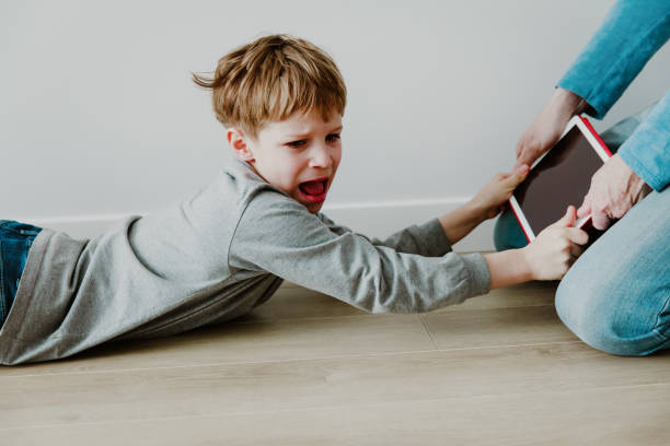 boy fighting for tablet - help, my child is looking at inappropriate content