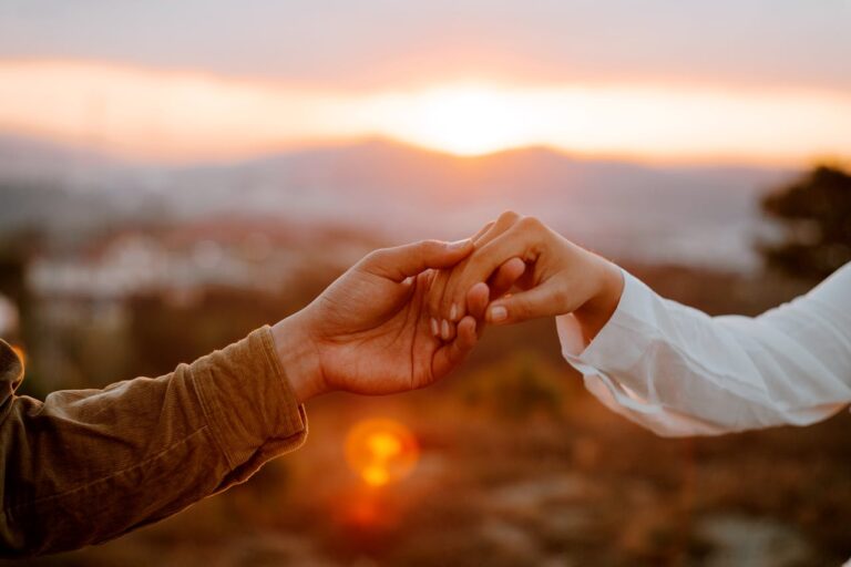 Holding hands with mountain sunset background, porn recovery and rebuilding healthy sexuality