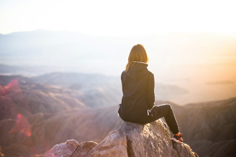 woman sitting on a mountain top women and accountability as a tool to quit porn