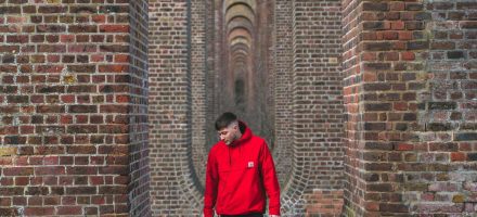 Guy in red sweatshirt standing in front of a brick tunnel how much porn is an addiction