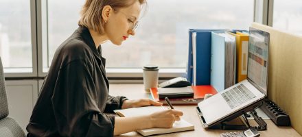 Woman at a computer writing on a list; Covenant Eyes Alternatives: The Best Accountability Apps for 2024