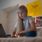 Girl on laptop in her bedroom internet safety tips