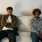 Man with arms crossed sitting next to a woman, the art of a fully accountable apology